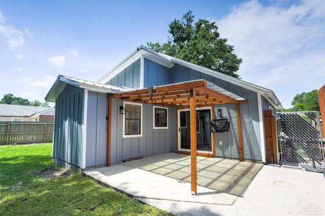 7402 Viewcrest Dr, Pensacola, FL 32504 - back of house featuring board and batten siding and a patio area