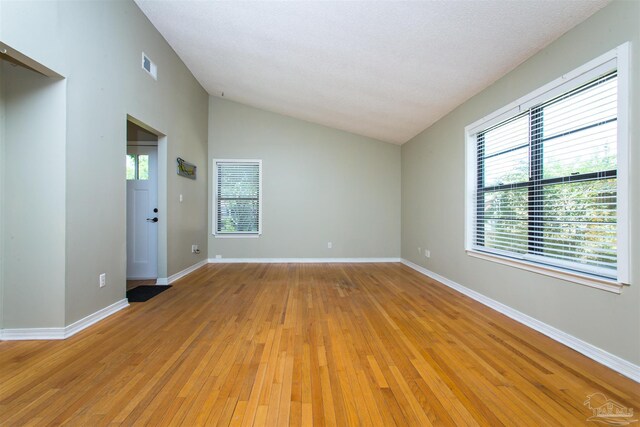 7402 Viewcrest Dr, Pensacola, FL 32504 - spare room featuring vaulted ceiling, light wood finished floors, and baseboards