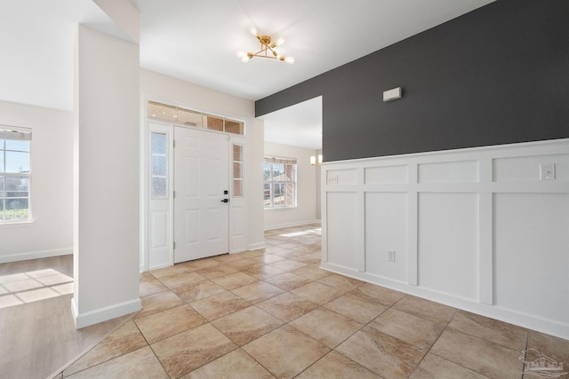 foyer entrance with plenty of natural light and an inviting chandelier