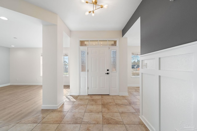 foyer entrance featuring a notable chandelier and a healthy amount of sunlight