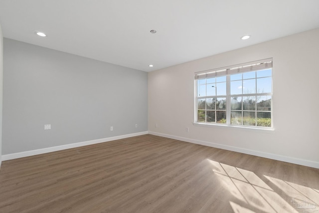 empty room with hardwood / wood-style floors