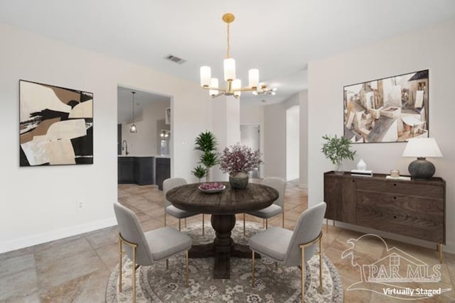 dining space with an inviting chandelier