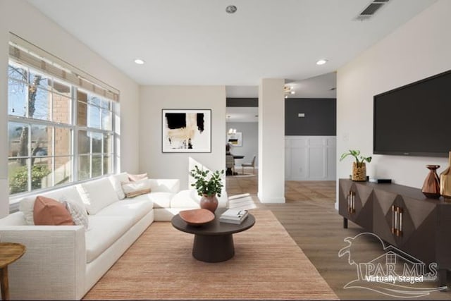 living room with light hardwood / wood-style flooring