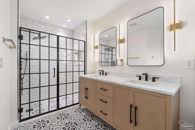 bathroom featuring tile patterned flooring, vanity, and a shower with shower door