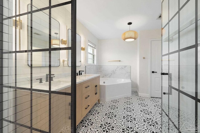 bathroom with a tub and vanity