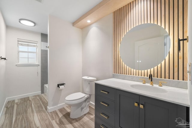 full bathroom featuring hardwood / wood-style floors, vanity, toilet, and tub / shower combination