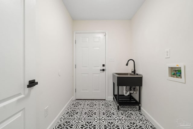 clothes washing area with sink and hookup for a washing machine