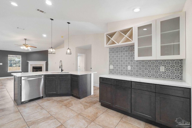 kitchen with backsplash, dishwasher, lofted ceiling, and sink