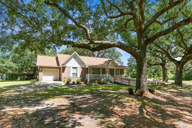 939 Avalon Blvd, Milton, FL 32583 - single story home with a porch, an attached garage, brick siding, and driveway