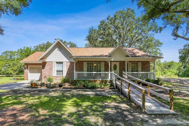 939 Avalon Blvd, Milton, FL 32583 - single story home with brick siding, covered porch, a garage, a front lawn, and driveway