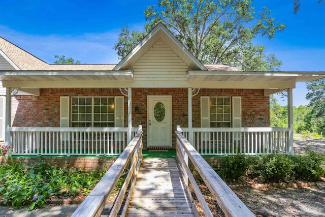 939 Avalon Blvd, Milton, FL 32583 - view of front facade featuring covered porch and brick siding