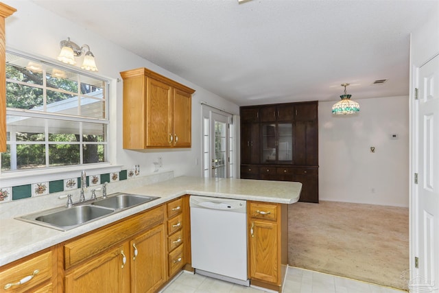 939 Avalon Blvd, Milton, FL 32583 - kitchen featuring dishwasher, light countertops, light carpet, and a peninsula