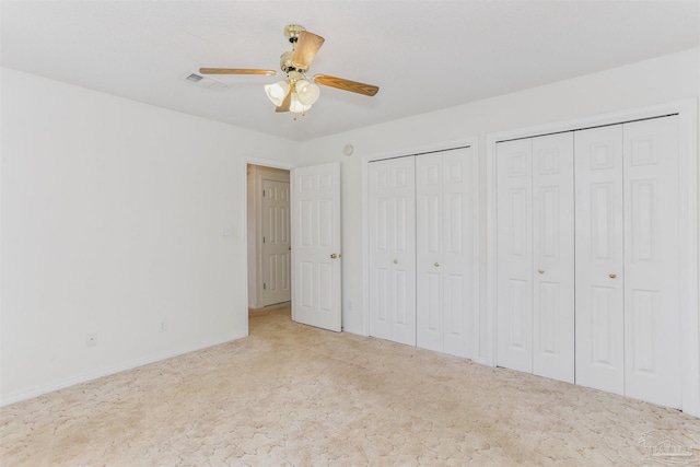 939 Avalon Blvd, Milton, FL 32583 - unfurnished bedroom featuring multiple closets, carpet, and a ceiling fan