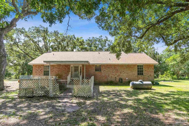 939 Avalon Blvd, Milton, FL 32583 - back of house featuring brick siding and a lawn