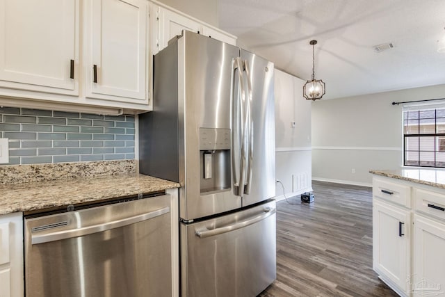 kitchen featuring decorative light fixtures, backsplash, appliances with stainless steel finishes, dark wood-type flooring, and white cabinetry