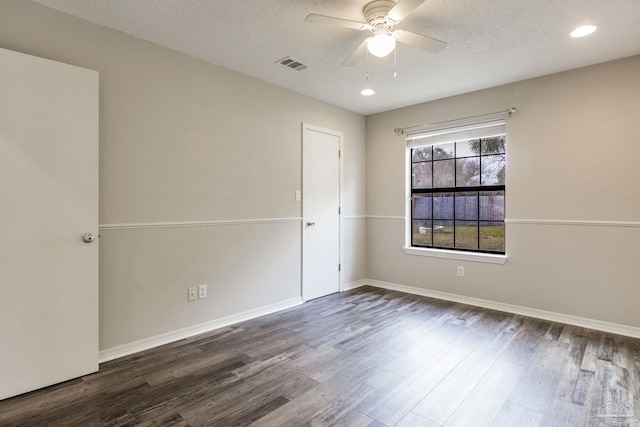 empty room with a textured ceiling, ceiling fan, wood finished floors, and visible vents