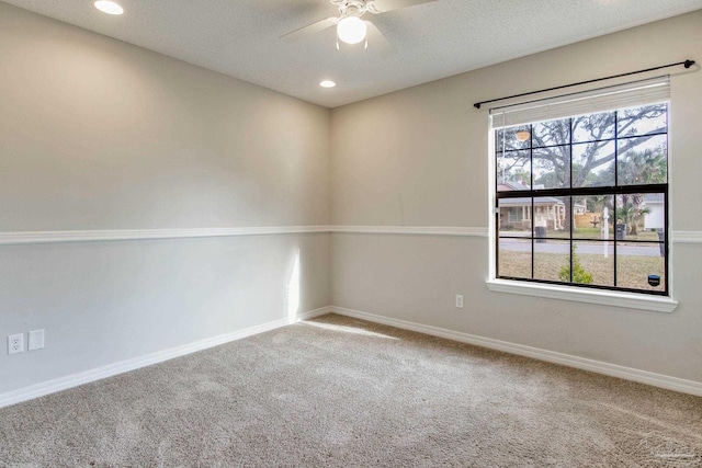 carpeted spare room featuring recessed lighting, a ceiling fan, and baseboards