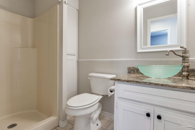 full bath with a stall shower, baseboards, toilet, tile patterned floors, and vanity