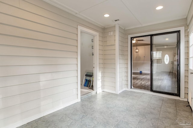 empty room featuring visible vents, built in features, crown molding, and recessed lighting