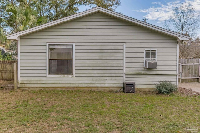 view of home's exterior featuring cooling unit, a yard, and fence