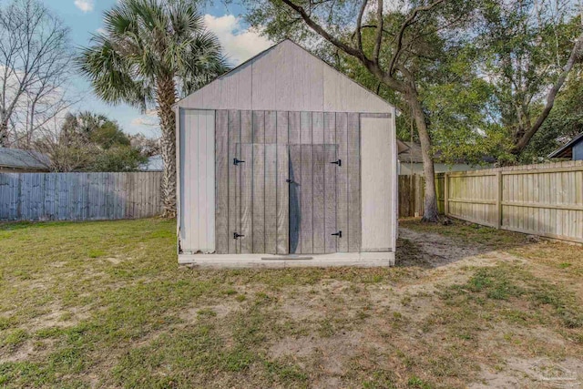 view of shed with a fenced backyard