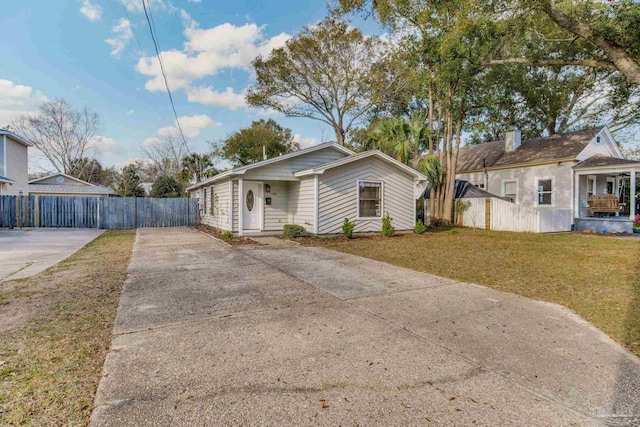 view of front of property with a front yard and fence