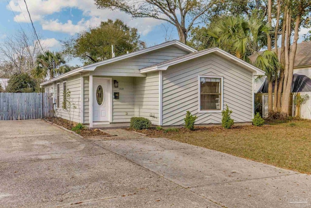 view of front of property with fence and a front lawn