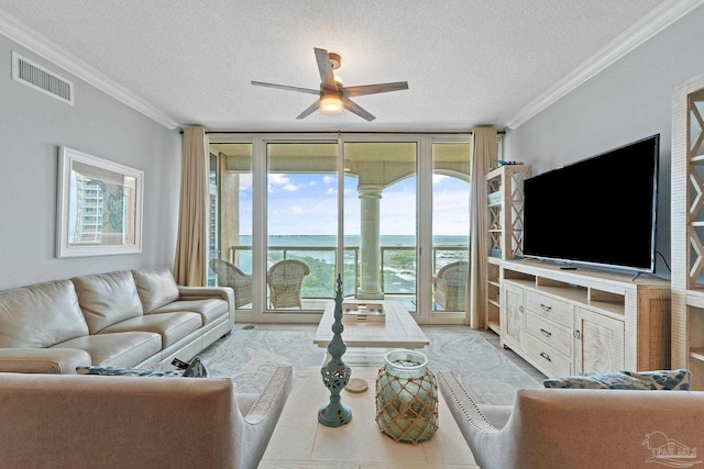 living room with floor to ceiling windows, ornamental molding, a textured ceiling, and a wealth of natural light