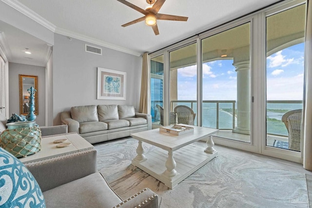 living room featuring a wall of windows, a water view, ceiling fan, and ornamental molding