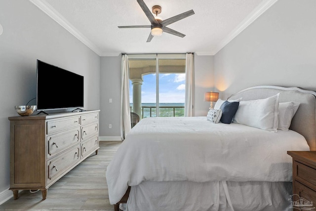 bedroom featuring access to exterior, light hardwood / wood-style flooring, ceiling fan, and crown molding