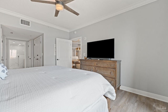 bedroom with ceiling fan, light wood-type flooring, ornamental molding, and connected bathroom