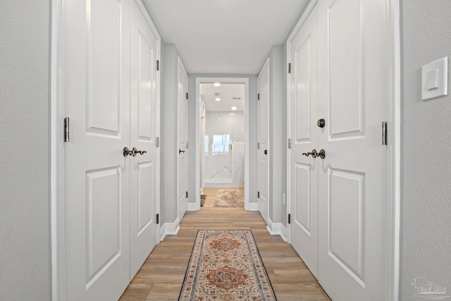 hallway with light wood-type flooring