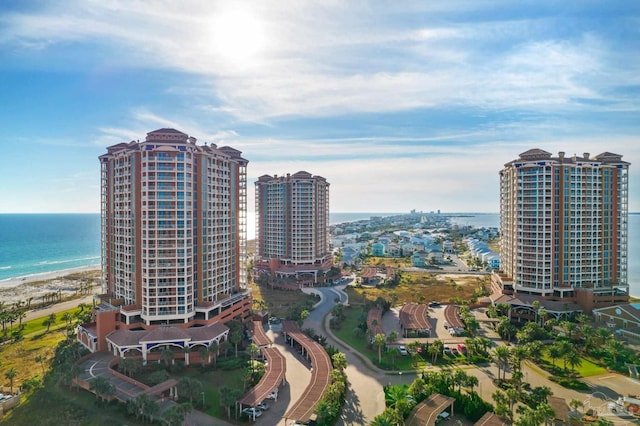 birds eye view of property with a water view and a view of the beach