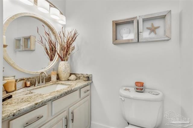 half bath featuring toilet and vanity