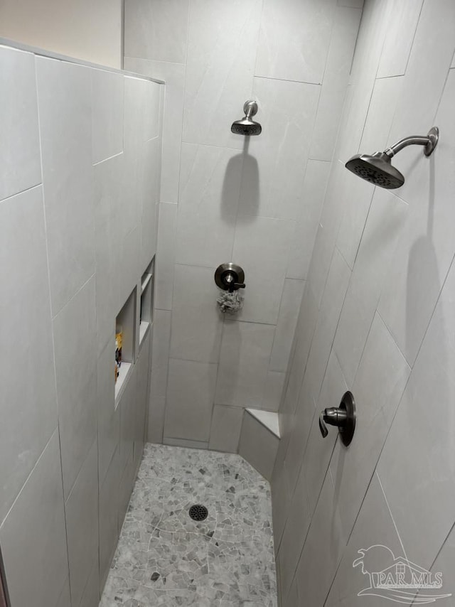 full bath featuring a tile shower