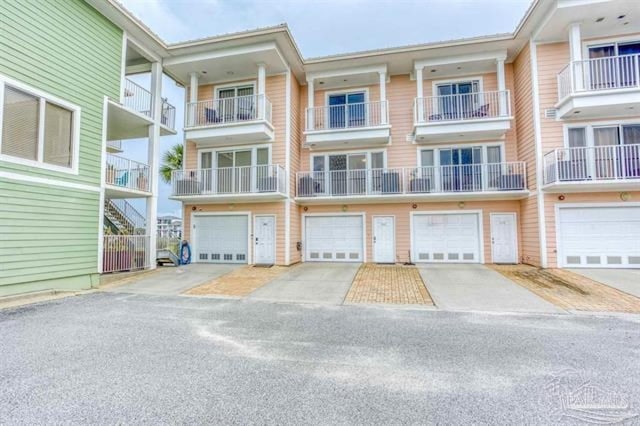 view of building exterior with an attached garage and driveway