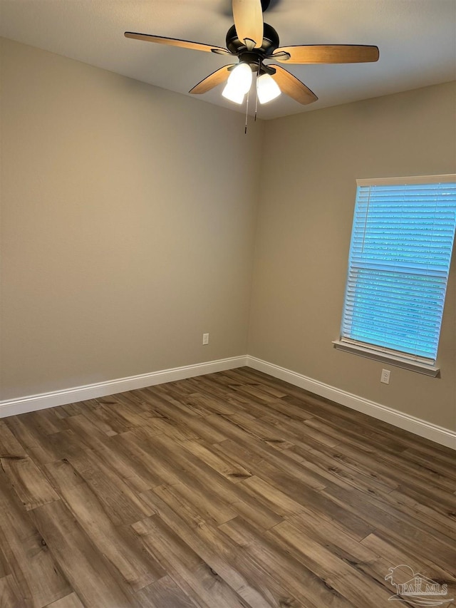 empty room featuring ceiling fan and dark wood-type flooring