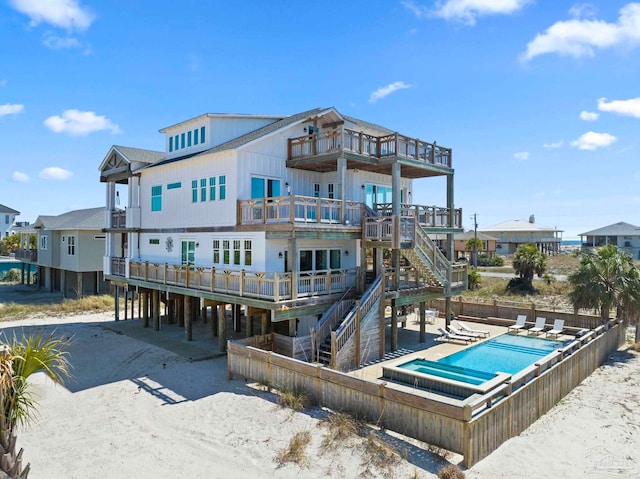 800 Via Deluna Dr, Pensacola Beach, FL 32561 - rear view of house featuring a patio, stairway, a balcony, a community pool, and fence private yard