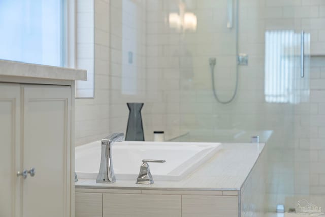 800 Via Deluna Dr, Pensacola Beach, FL 32561 - bathroom with a bathtub, a tile shower, tile walls, and a sink