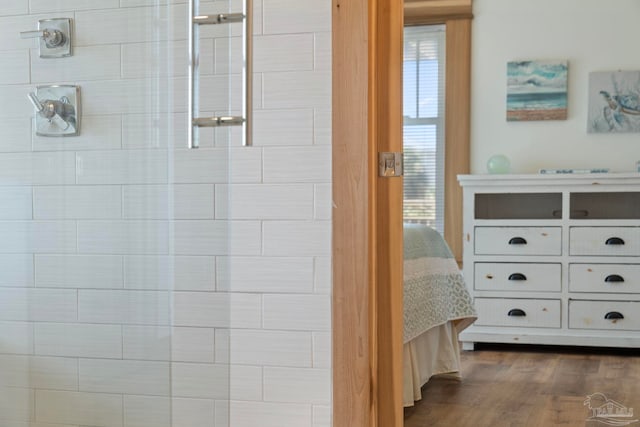 800 Via Deluna Dr, Pensacola Beach, FL 32561 - bathroom with tiled shower, wood finished floors, and ensuite bathroom