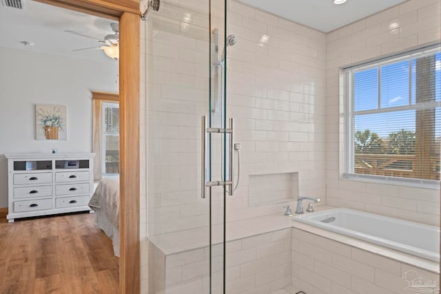 800 Via Deluna Dr, Pensacola Beach, FL 32561 - bathroom featuring wood finished floors, visible vents, ceiling fan, a shower stall, and a garden tub