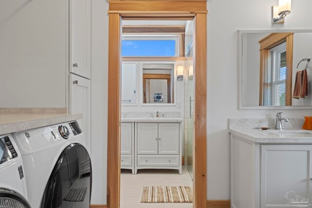 800 Via Deluna Dr, Pensacola Beach, FL 32561 - washroom with cabinet space, independent washer and dryer, and a sink