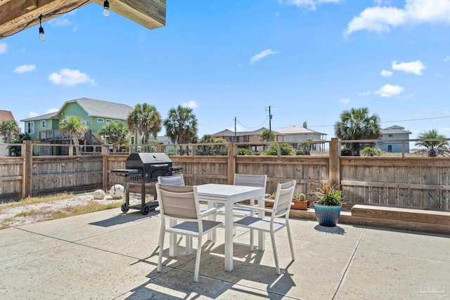 800 Via Deluna Dr, Pensacola Beach, FL 32561 - view of patio featuring outdoor dining area, area for grilling, and fence