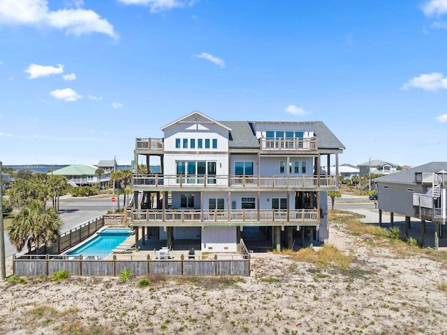 800 Via Deluna Dr, Pensacola Beach, FL 32561 - back of property with a community pool, a balcony, a fenced backyard, and a patio area