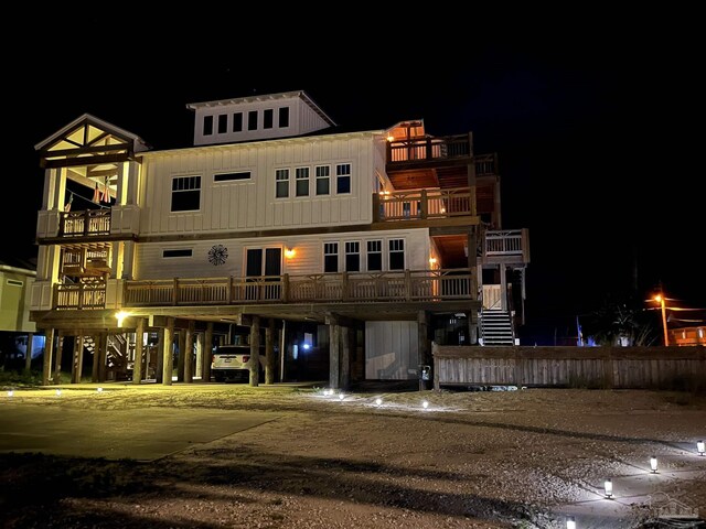 800 Via Deluna Dr, Pensacola Beach, FL 32561 - back of house at twilight featuring a carport and board and batten siding