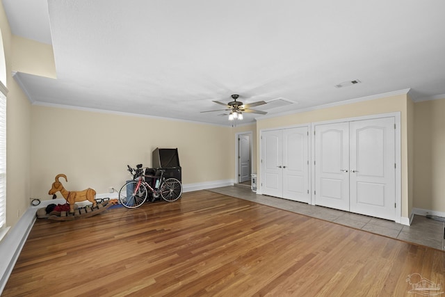 4621 Riley Rd, Milton, FL 32583 - unfurnished bedroom with wood finished floors, multiple closets, ornamental molding, and a ceiling fan