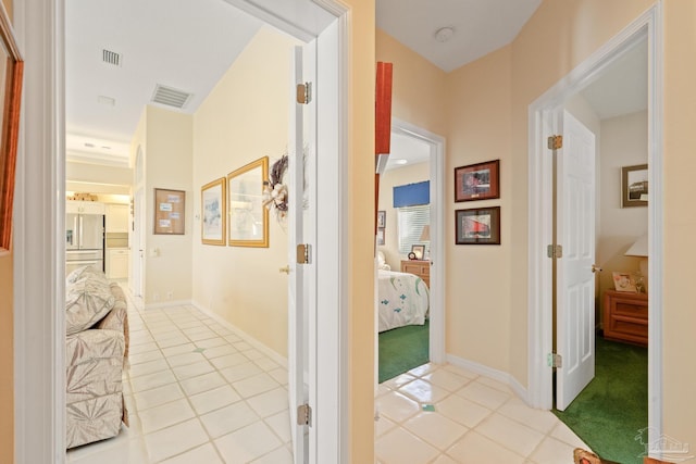 hall featuring light tile patterned floors