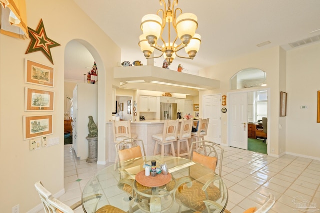 dining room with light tile patterned flooring and an inviting chandelier