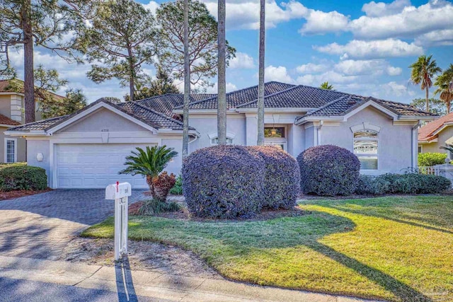 view of front of home featuring a front yard and a garage