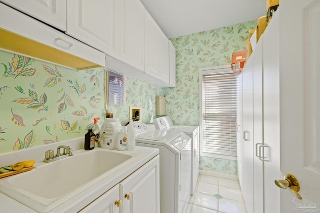 washroom featuring cabinets, washing machine and dryer, light tile patterned floors, and sink